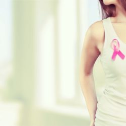 Woman with pink breast cancer ribbon wondering about mammogram guidelines | cCARE | San Diego & Fresno, CA