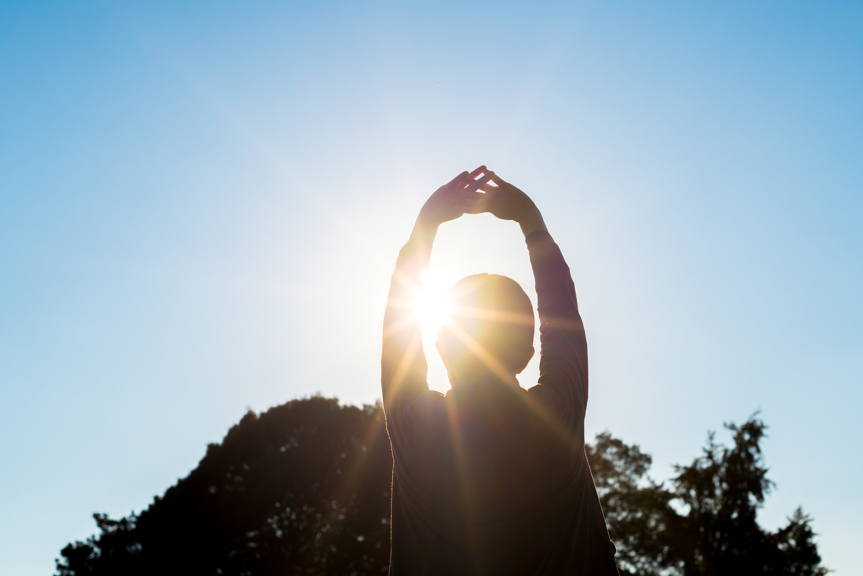 immunotherapy cancer research | woman stretching in sunlight | California Cancer Associates