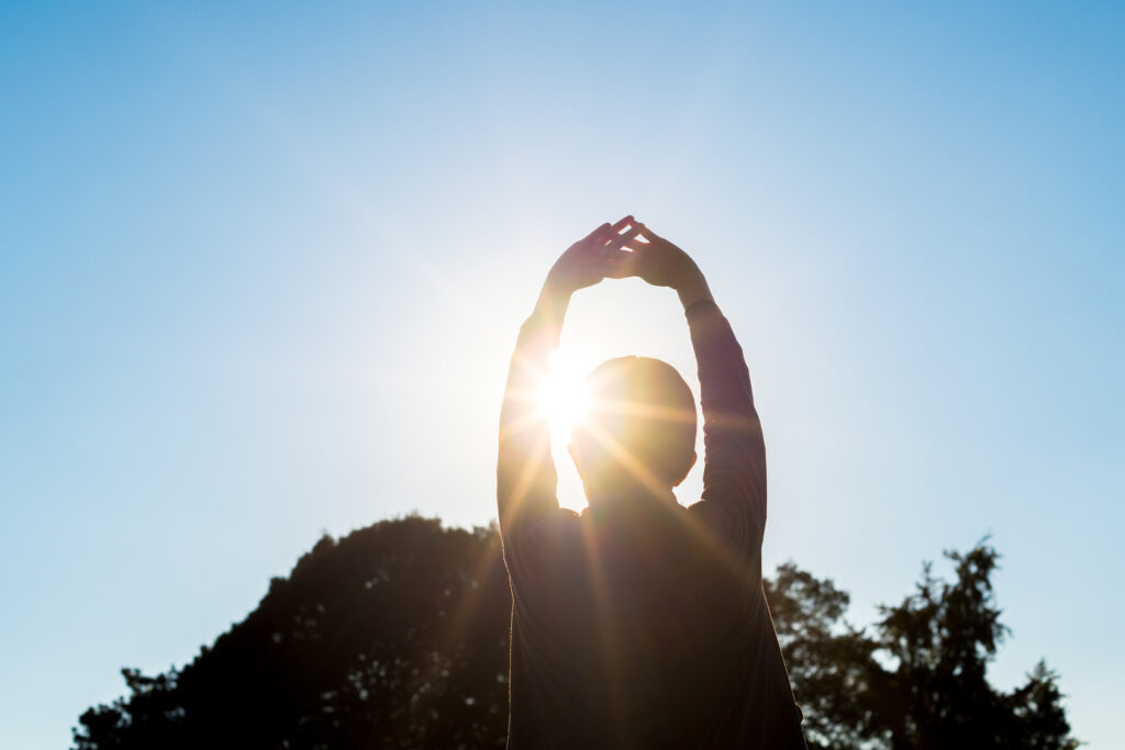 Woman stretching in sunlight
