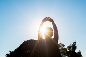 Woman stretching in sunlight