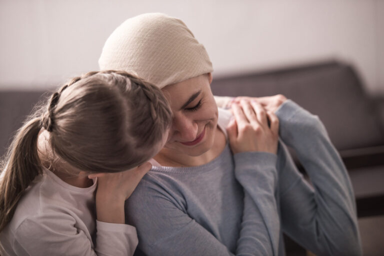 child hugging and supporting sick mother in kerchief